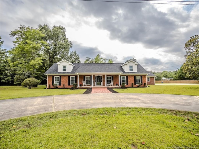 5307 N Fayetteville Rd, Lumberton, NC 28360 - view of front of home with brick siding, covered porch, driveway, and roof with shingles