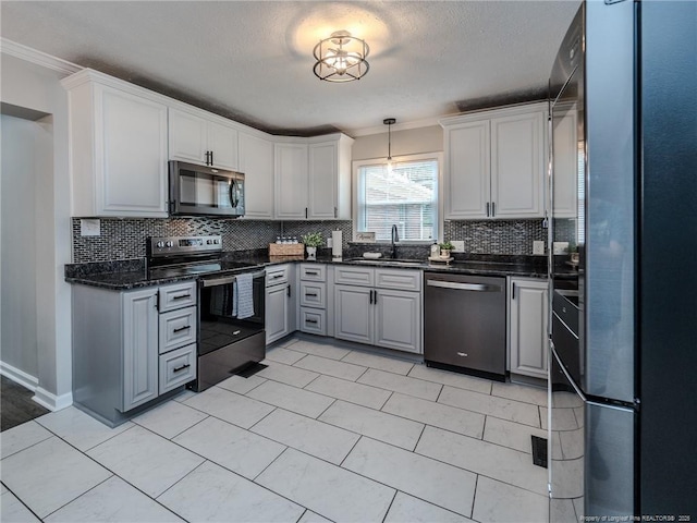 5307 N Fayetteville Rd, Lumberton, NC 28360 - kitchen with appliances with stainless steel finishes, a sink, ornamental molding, backsplash, and pendant lighting