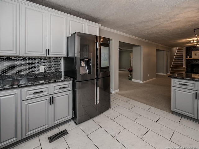 5307 N Fayetteville Rd, Lumberton, NC 28360 - kitchen with fridge with ice dispenser, a textured ceiling, white cabinets, tasteful backsplash, and crown molding