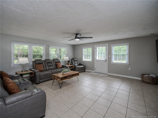 5307 N Fayetteville Rd, Lumberton, NC 28360 - living room featuring ceiling fan, baseboards, light tile patterned floors, and a textured ceiling