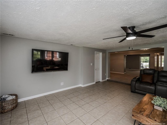 5307 N Fayetteville Rd, Lumberton, NC 28360 - living area with a textured ceiling, a ceiling fan, baseboards, and light tile patterned floors