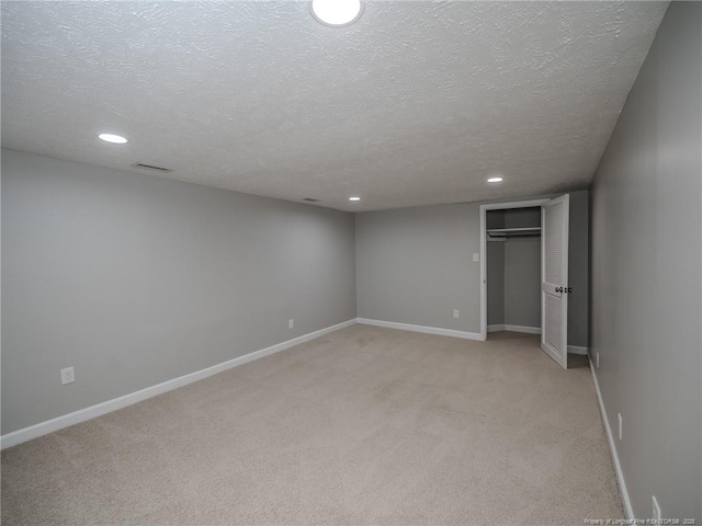 5307 N Fayetteville Rd, Lumberton, NC 28360 - unfurnished bedroom with a textured ceiling, light carpet, recessed lighting, baseboards, and a closet