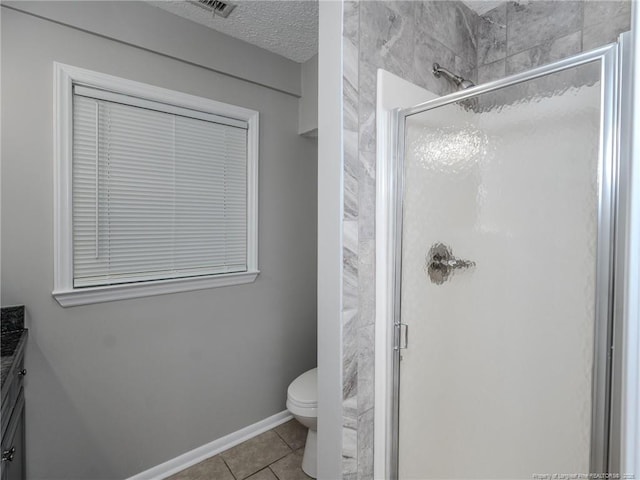 5307 N Fayetteville Rd, Lumberton, NC 28360 - bathroom featuring a stall shower, toilet, vanity, tile patterned floors, and a textured ceiling