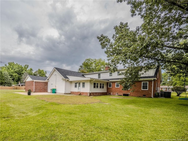 5307 N Fayetteville Rd, Lumberton, NC 28360 - rear view of house with brick siding, a patio area, a chimney, and crawl space