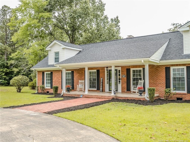 5307 N Fayetteville Rd, Lumberton, NC 28360 - view of front of property with brick siding, a shingled roof, a front lawn, and a porch
