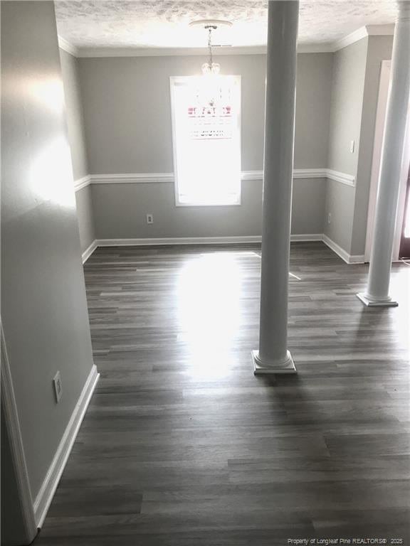 330 Bubble Creek Ct Unit 8, Fayetteville, NC 28311 - empty room featuring ornamental molding, baseboards, dark wood finished floors, a chandelier, and a textured ceiling