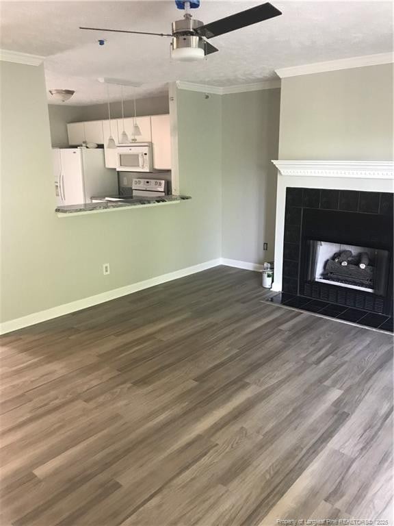 330 Bubble Creek Ct Unit 8, Fayetteville, NC 28311 - unfurnished living room featuring a ceiling fan, dark wood-type flooring, baseboards, a tile fireplace, and crown molding