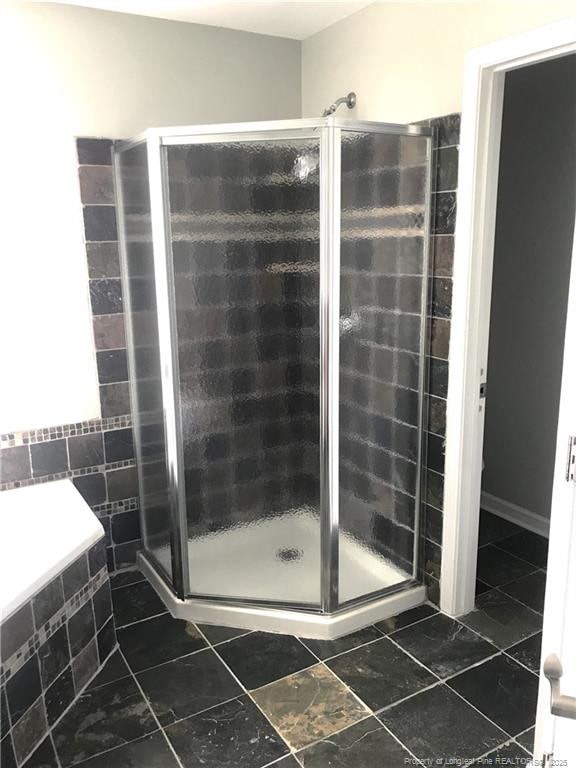 330 Bubble Creek Ct Unit 8, Fayetteville, NC 28311 - bathroom with a shower stall, tile walls, and tile patterned flooring