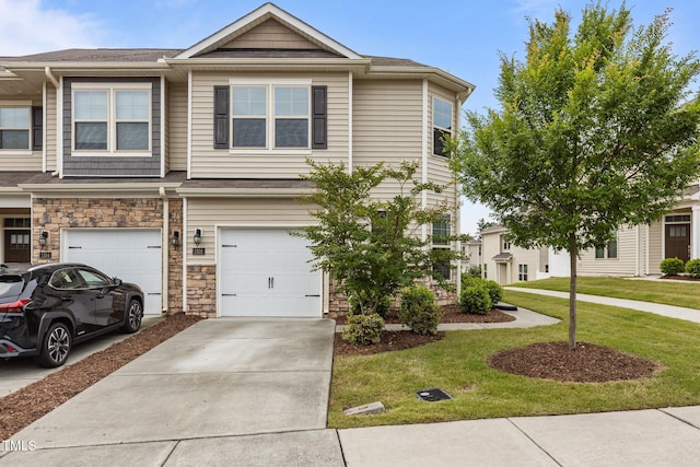 1102 Latitude Dr, Durham, NC 27713 - multi unit property with a front yard, concrete driveway, an attached garage, and stone siding