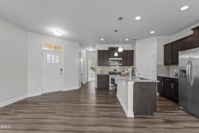 1102 Latitude Dr, Durham, NC 27713 - kitchen featuring appliances with stainless steel finishes, a sink, dark wood-style flooring, backsplash, and recessed lighting