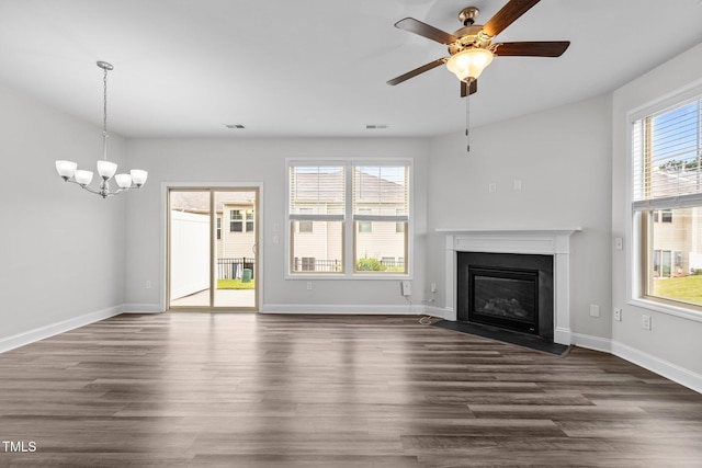 1102 Latitude Dr, Durham, NC 27713 - unfurnished living room with a fireplace with flush hearth, dark wood-style floors, a chandelier, and baseboards