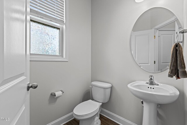 1102 Latitude Dr, Durham, NC 27713 - bathroom with toilet, baseboards, and wood finished floors