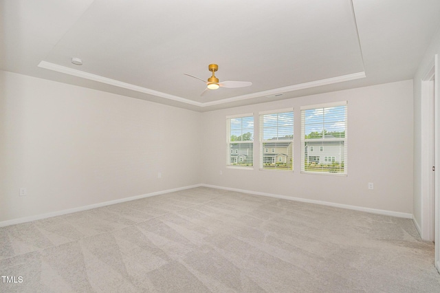 1725 Winter Jasmine Ln, Wake Forest, NC 27587 - spare room featuring a raised ceiling, ceiling fan, light carpet, and baseboards