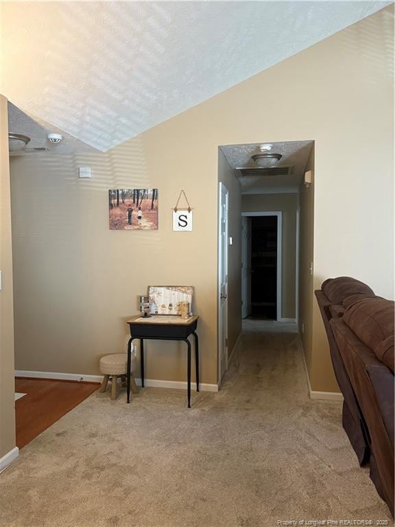 135 Paulownia Dr, Saint Pauls, NC 28384 - corridor with carpet flooring, vaulted ceiling, and baseboards