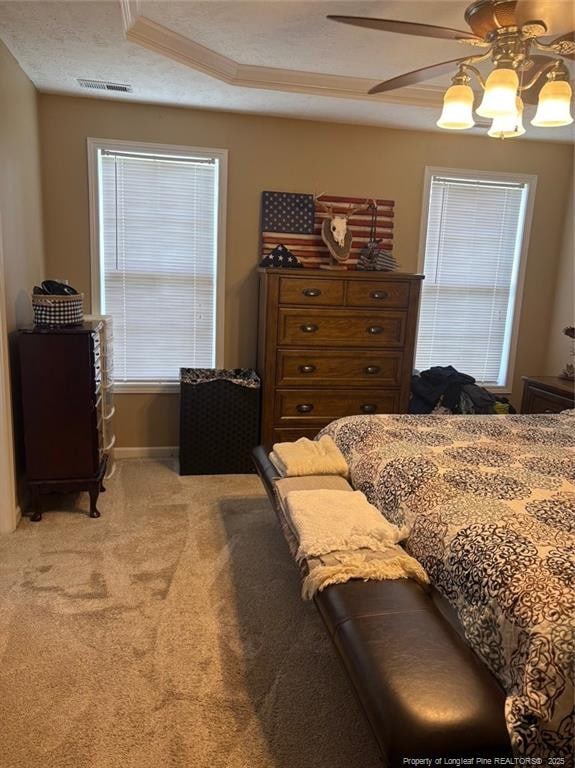 135 Paulownia Dr, Saint Pauls, NC 28384 - bedroom featuring light colored carpet, ornamental molding, a ceiling fan, baseboards, and a tray ceiling