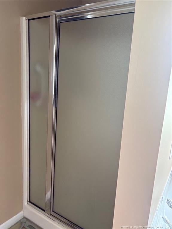 135 Paulownia Dr, Saint Pauls, NC 28384 - full bathroom with a stall shower and baseboards