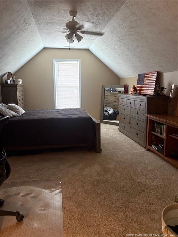 135 Paulownia Dr, Saint Pauls, NC 28384 - bedroom featuring a textured ceiling, lofted ceiling, carpet floors, and a ceiling fan