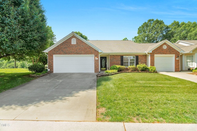3027 Maple Ave Unit A-1, Burlington, NC 27215 - ranch-style home with an attached garage, driveway, brick siding, and a front yard