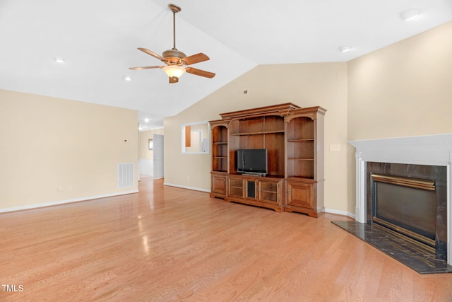 3027 Maple Ave Unit A-1, Burlington, NC 27215 - unfurnished living room with ceiling fan, light wood-type flooring, lofted ceiling, a fireplace, and baseboards