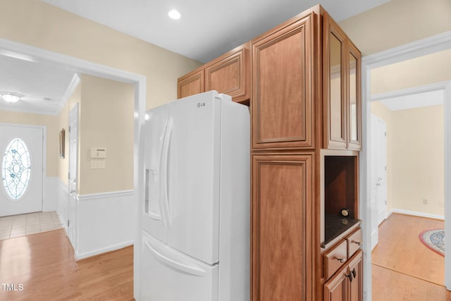 3027 Maple Ave Unit A-1, Burlington, NC 27215 - kitchen featuring white fridge with ice dispenser, light wood-type flooring, wainscoting, brown cabinetry, and recessed lighting