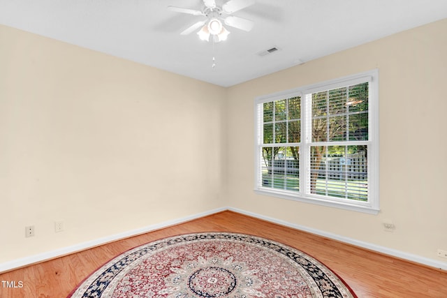 3027 Maple Ave Unit A-1, Burlington, NC 27215 - empty room featuring wood finished floors, baseboards, and ceiling fan