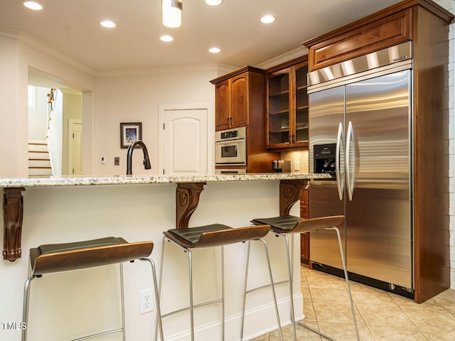 410 Mountain Laurel, Chapel Hill, NC 27517 - kitchen with stainless steel appliances, crown molding, recessed lighting, glass insert cabinets, and a breakfast bar