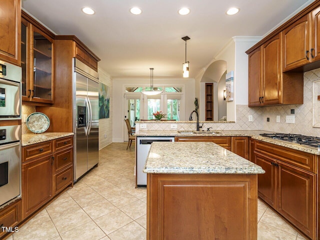 410 Mountain Laurel, Chapel Hill, NC 27517 - kitchen featuring appliances with stainless steel finishes, a sink, light tile patterned floors, tasteful backsplash, and crown molding