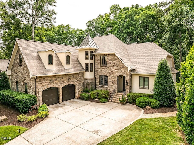 410 Mountain Laurel, Chapel Hill, NC 27517 - french country home featuring stucco siding, stone siding, concrete driveway, and roof with shingles