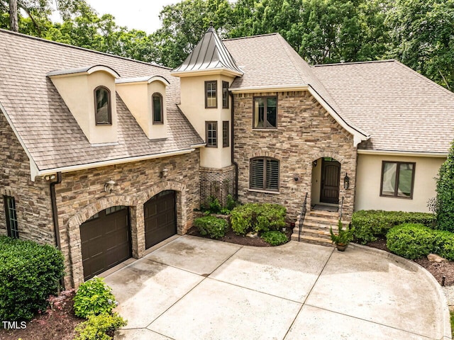 410 Mountain Laurel, Chapel Hill, NC 27517 - french country home with stucco siding, stone siding, driveway, a shingled roof, and a standing seam roof