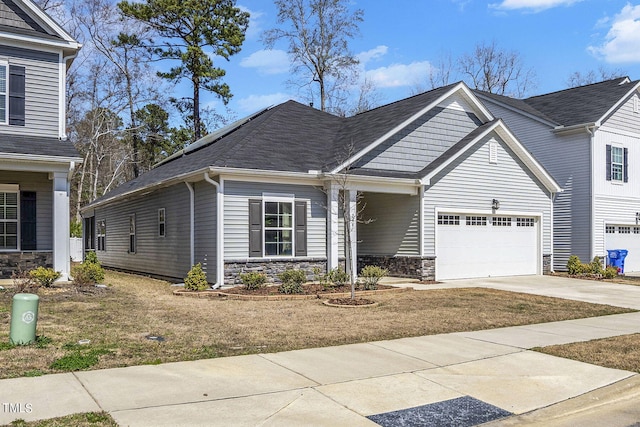 244 Chateau Way, Angier, NC 27501 - view of front of house featuring stone siding, concrete driveway, and a garage