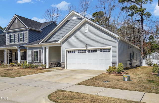 244 Chateau Way, Angier, NC 27501 - view of front of property featuring an attached garage, driveway, and stone siding