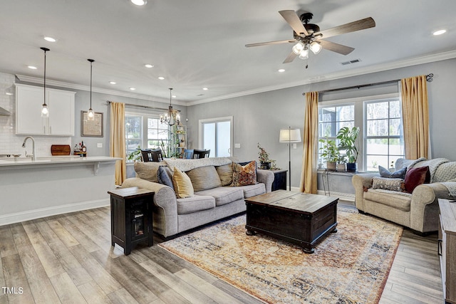 244 Chateau Way, Angier, NC 27501 - living room with light wood-style flooring, a ceiling fan, recessed lighting, a chandelier, and ornamental molding