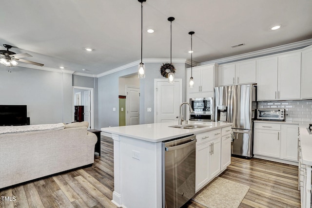 244 Chateau Way, Angier, NC 27501 - kitchen with stainless steel appliances, ornamental molding, open floor plan, light wood-style floors, and ceiling fan
