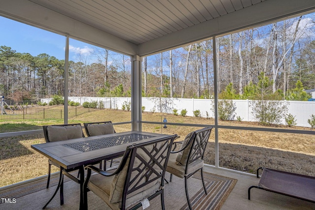 244 Chateau Way, Angier, NC 27501 - sunroom featuring outdoor dining space, healthy amount of natural light, and view of wooded area