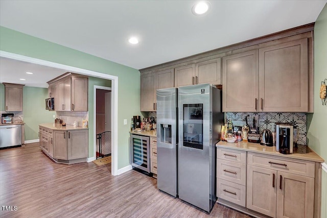 750 Greenleaf Rd, Angier, NC 27501 - kitchen featuring stainless steel appliances, wine cooler, backsplash, light wood-style flooring, and light countertops