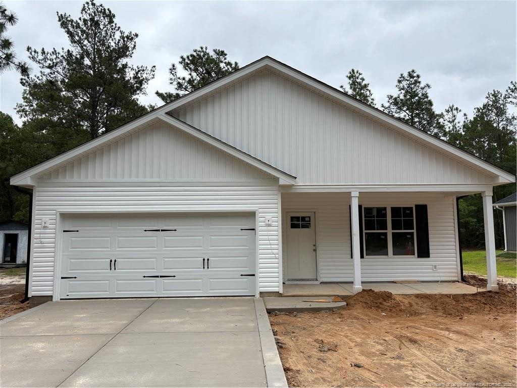 924 Stevens St, Raeford, NC 28376 - view of front of house with a porch, driveway, and an attached garage