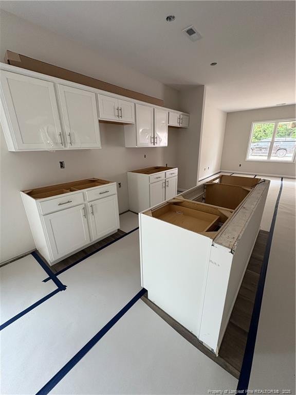 924 Stevens St, Raeford, NC 28376 - kitchen featuring white cabinets and a center island