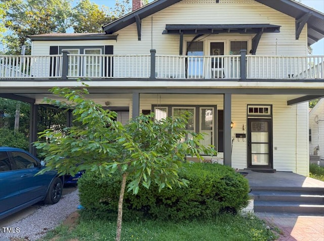 1406 Gold St N, Wilson, NC 27893 - view of front of home featuring a balcony, a chimney, and a porch