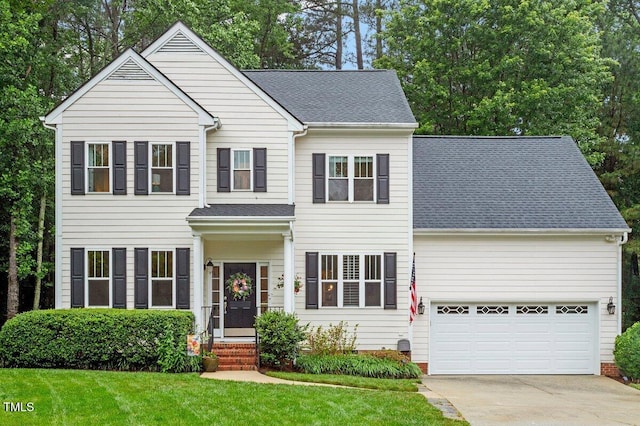 4329 Hawksong Pl, Cary, NC 27518 - traditional home with concrete driveway, a front lawn, roof with shingles, and an attached garage