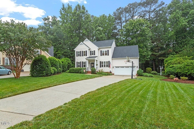 4329 Hawksong Pl, Cary, NC 27518 - colonial home with driveway, a front lawn, and a garage