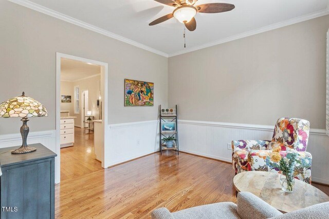 4329 Hawksong Pl, Cary, NC 27518 - sitting room featuring wainscoting, light wood-style floors, crown molding, and a ceiling fan