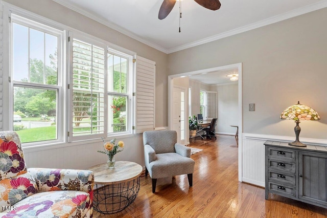 4329 Hawksong Pl, Cary, NC 27518 - sitting room with light wood finished floors, wainscoting, crown molding, and ceiling fan