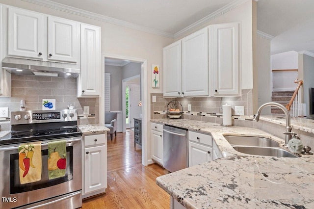 4329 Hawksong Pl, Cary, NC 27518 - kitchen featuring stainless steel appliances, under cabinet range hood, a sink, ornamental molding, and white cabinets
