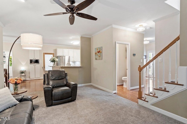 4329 Hawksong Pl, Cary, NC 27518 - living area featuring ornamental molding, a ceiling fan, light colored carpet, stairs, and healthy amount of natural light