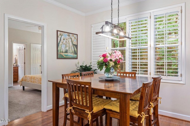 4329 Hawksong Pl, Cary, NC 27518 - dining space with a chandelier, healthy amount of natural light, baseboards, wood finished floors, and ornamental molding