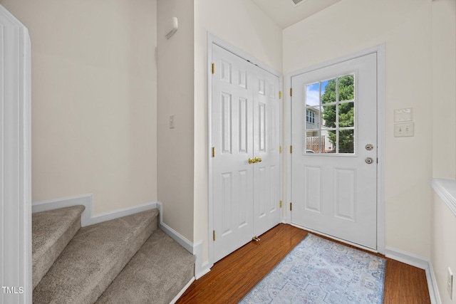 8151 Rhiannon Rd, Raleigh, NC 27613 - entryway with wood finished floors and stairway