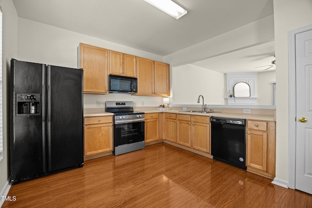 8151 Rhiannon Rd, Raleigh, NC 27613 - kitchen featuring black appliances, light countertops, wood finished floors, and a ceiling fan