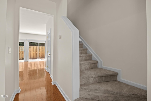 8151 Rhiannon Rd, Raleigh, NC 27613 - staircase featuring wood finished floors and baseboards