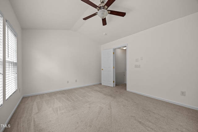 8151 Rhiannon Rd, Raleigh, NC 27613 - empty room with ceiling fan, vaulted ceiling, light colored carpet, and healthy amount of natural light
