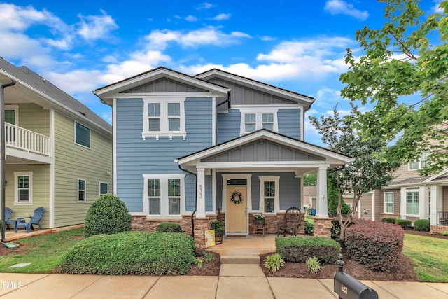 533 Duchart Ln, Fuquay Varina, NC 27526 - view of front of property featuring board and batten siding, covered porch, and stone siding